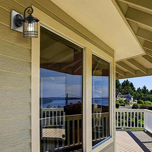 Outdoor wall lantern on porch with view of trees and buildings