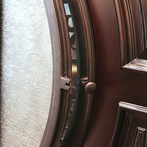 Closeup of a decorative door with glass panel.