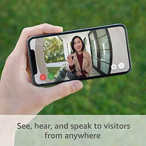 Person holding smartphone showing a video call with a woman waving.